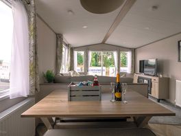 Kitchen and Living Area in standard 3 bedroom static caravan. Prosecco & hamper is not standard