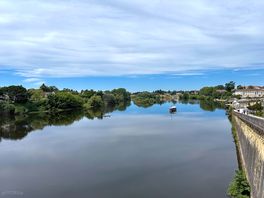 Site on left bank, old town on right.