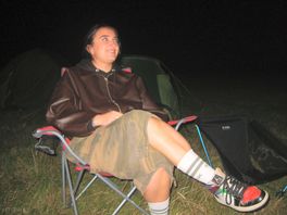 Girl smiling sitting on camping chair