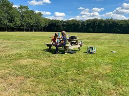 My boys enjoying snacks and games on the picnic bench