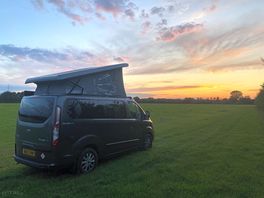 Campervan in front of beautiful sunset