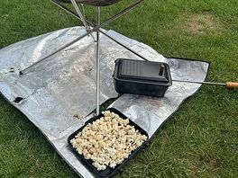 Cooking popcorn on an open fire.