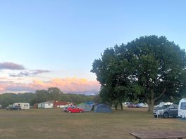 Sunsets over main buildings and woods