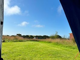 View from our tent looking out onto the football pitch, playground and shower block.