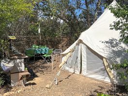 Glamping area- there’s also a seating area with a hammock next to the tent.