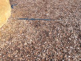 Underlying plastic coming through the woodchip, looks messy and its very slippery!