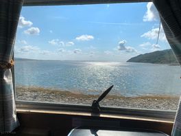 View looking out at high tide across estuary