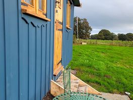 The shepherds hut with the seating area.