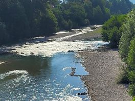 Directly by the river