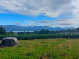 View of the sea and mountains from camping field