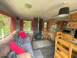 The livingroom/resting area is joined with the kitchen, both being fully furnished