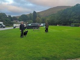 View over grass pitch towards river walk