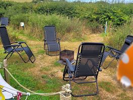 Cosy fireplace area and chairs provided.