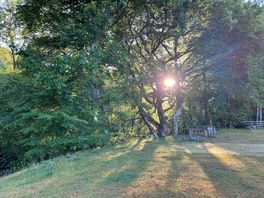 Pitch view, next to stream with picnic bench and fire pit