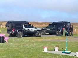 Neighboring adventure vehicles and film crew