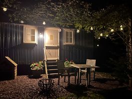 Outside of the hut with the lights on