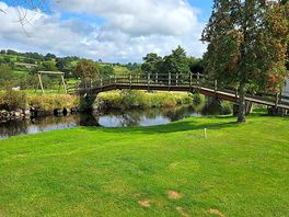 Bridge over river to play area