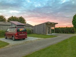 Sunset behind one of the hard-standing pitches and the washup/laundry block