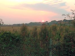 Twilight view over fields at back of grasmere caravan park in caister