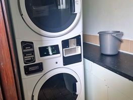 Laundry room. washing machine & tumble dryer & a shelf