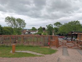The view of the aviary and path to the pub and shop/cafe.