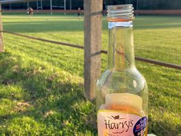 Watching rugby training with a cider for the campsite