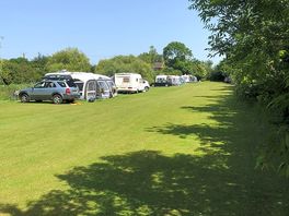 Peaceful pitches by a small fishing lake