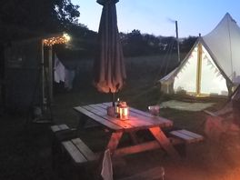 Bell tent at night with fairy lights