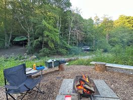 The view of our campfire and two of the hanging tent options in the background.