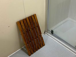 Wooden floor mat in cubicle