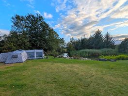 Tent pitch and pond.