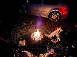 Sitting around a campfire eating smores