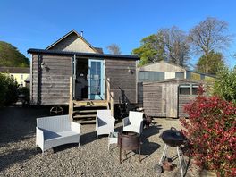 Shepherds hut with the bathroom facilities alongside.