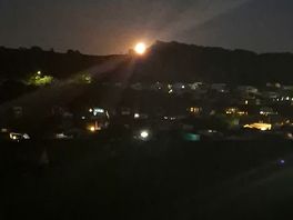 Golden moon peering out over lancaster/morecambe