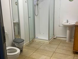 Looking into the washroom. dirty looking floor.