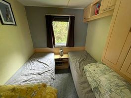 A cozy room for children, once again fully furnished, additionally having cohple of books and games