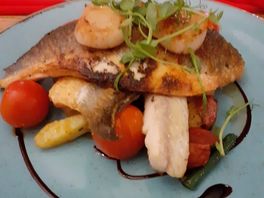 Grilled sea bass on a warm salad with new potatoes, chorizo and scallops.