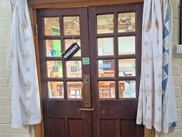 Door out of bathroom with curtains open.