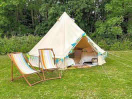 Belle tent surrounded by greenery