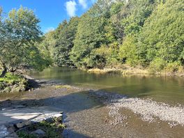 River runs past the site