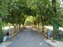 Lovely tree lined entrance leading to the electronic gate and keypad for easy self check-ins.