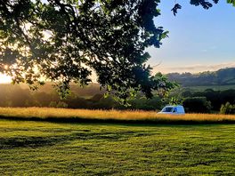 Beautiful sunset over the wild camping field