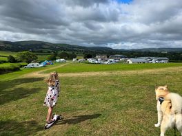 Granddaughter and dog enjoying walk on the open green space on site.