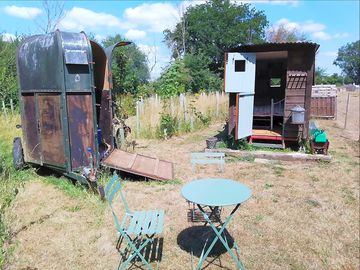 Shepherd's hut on the right and living room iun a horse box to the left