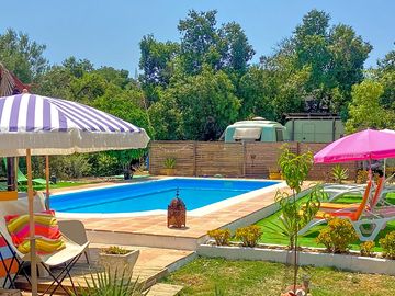 Swimming pool with loungers