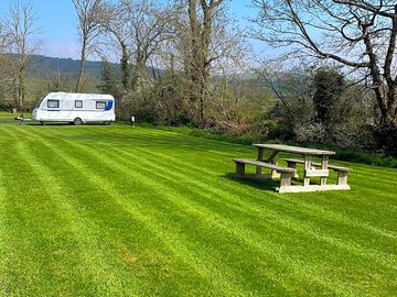 A spacious grass pitch for tents, motorhomes and campervans.