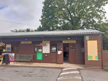 Coin-operated launderette next to reception and shop