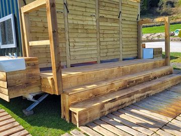 Unisex toilet/shower trailer with hot showers and drinking water
