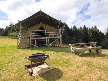 Front of canol y cae with barbecue, firepit and picnic table