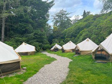 Bell tents arranged around a gravel path